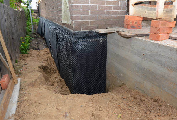 Happy homeowners after waterproofing job in Homer